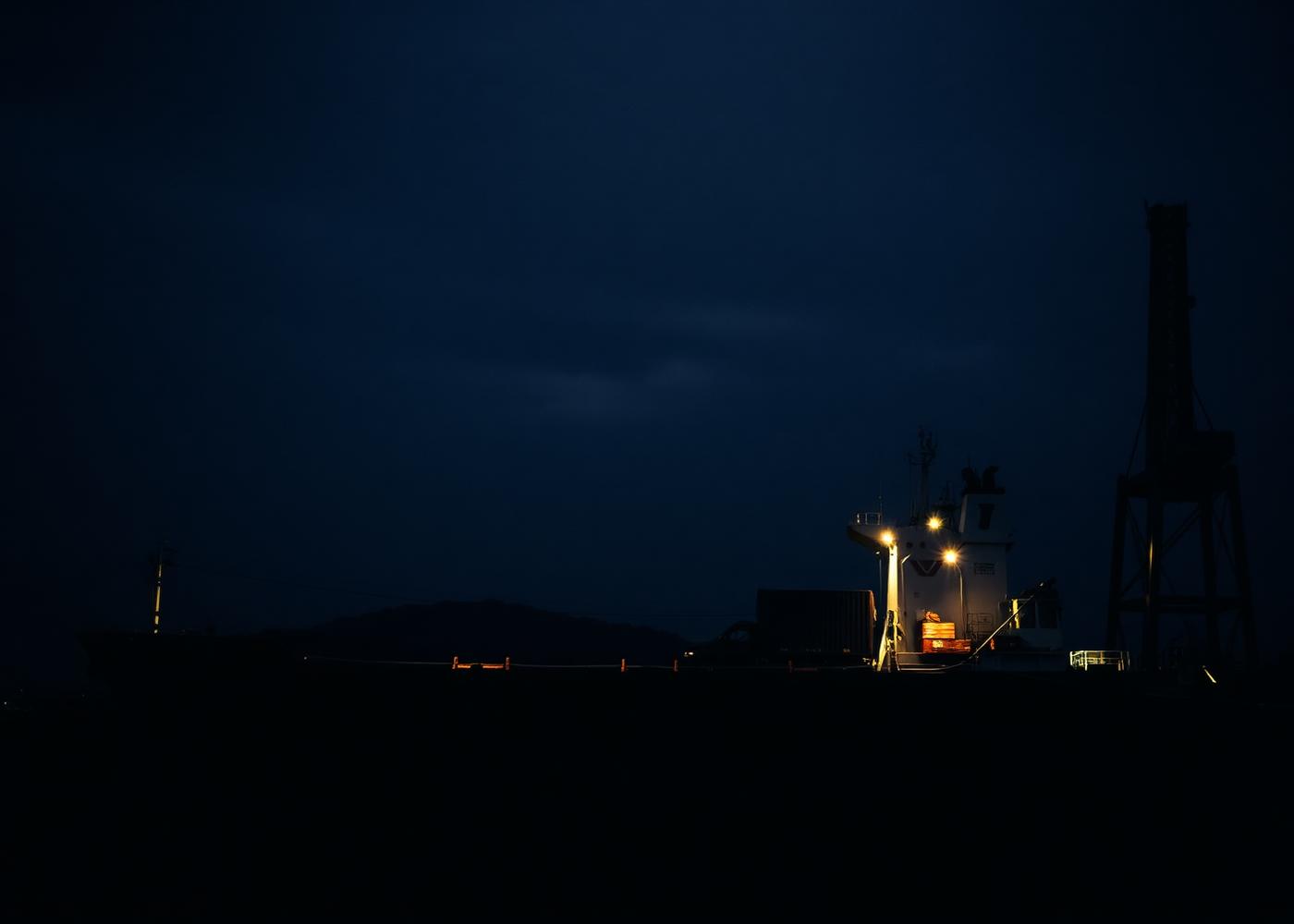 Vehicle carrier at a port at dusk